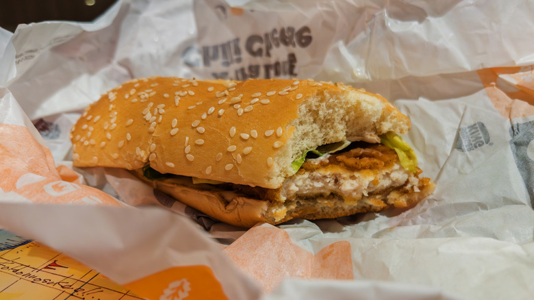 Crispy chicken sandwich from Burger King, with a bite taken out of it