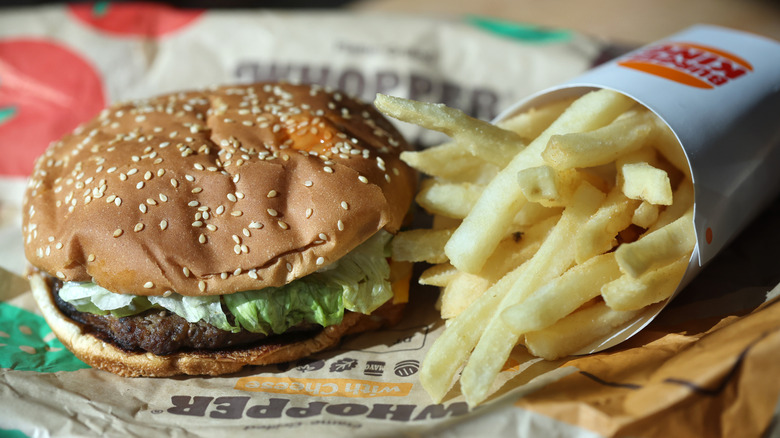 Burger King Whopper and fries resting on paper
