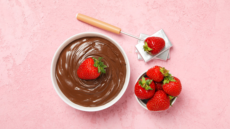 Bowl of chocolate fondue with fresh strawberries