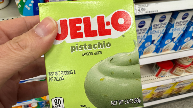 Person holds a box of Jell-O Pistachio Instant Pudding