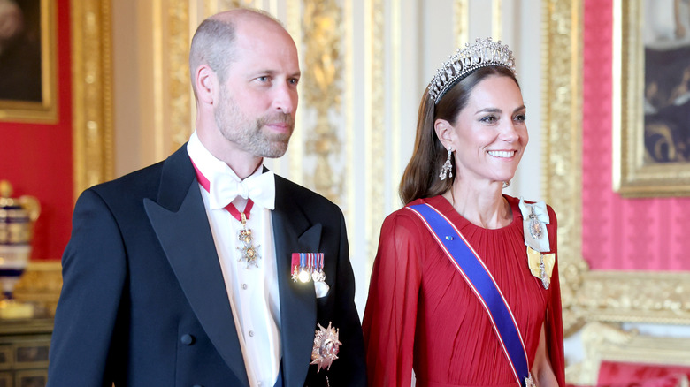 Prince William and Kate Middleton smile while posing