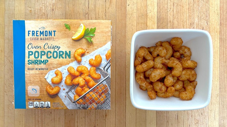 Box and white bowl of Fremont Fish Market Oven Crispy Popcorn Shrimp