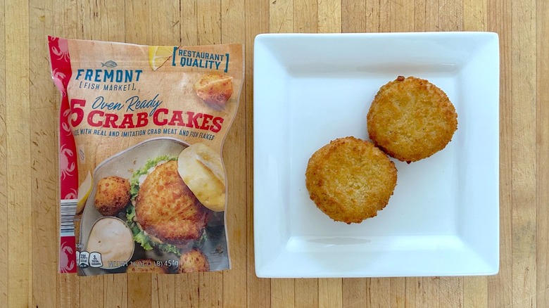 Bag and white plate of Fremont Fish Market Crab Cakes