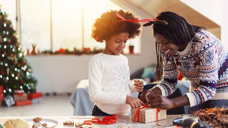Mother and daughter packaging cookies