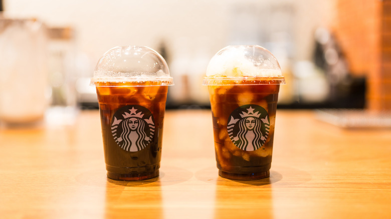 Two plastic Starbucks cups filled with iced coffee