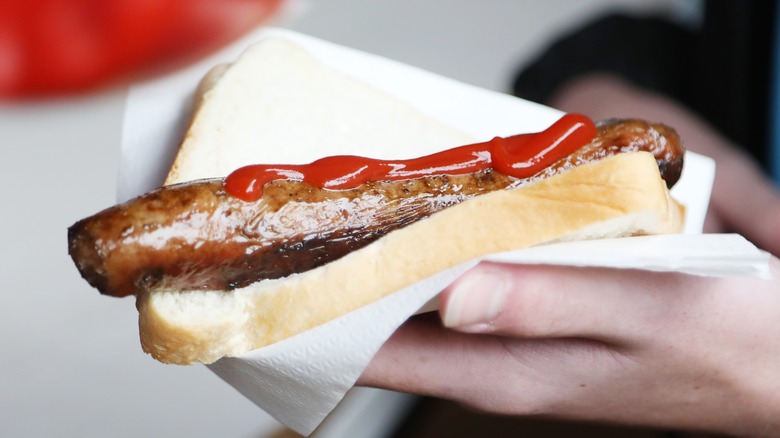 sausage sandwich in a hand