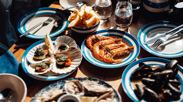 Various plates of seafood in a restaurant setting