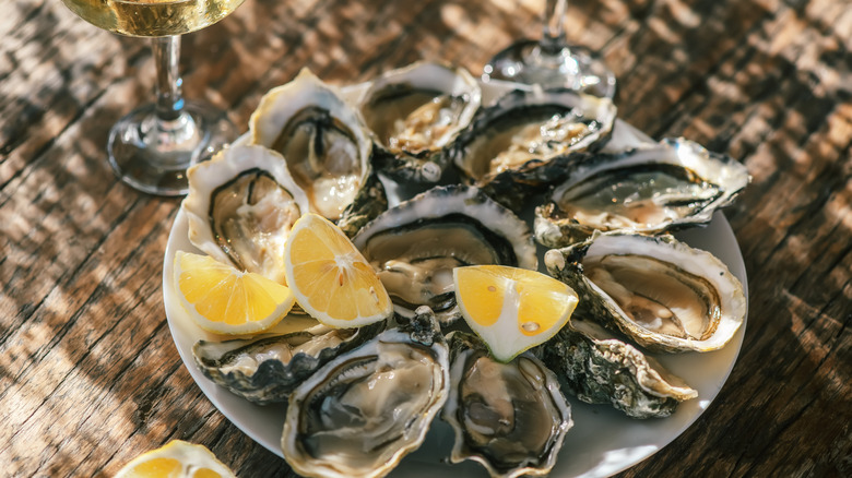 Fresh oysters and lemon wedges