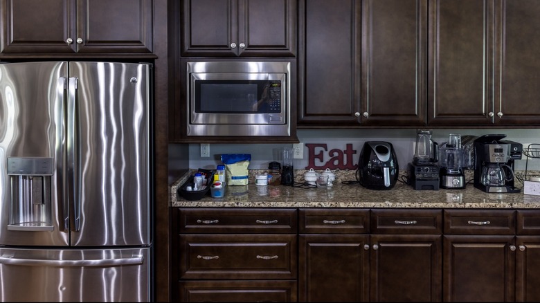 dark wooded old kitchen with metal appliances