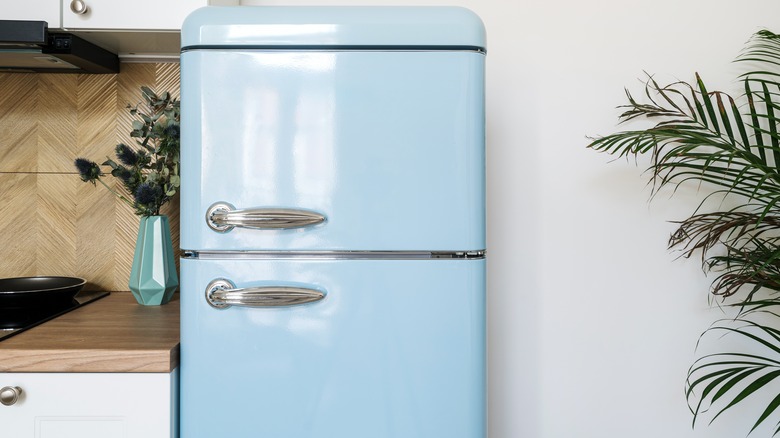 A pastel blue refrigerator in a modern kitchen