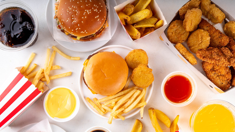 Several fast food items on a white table together