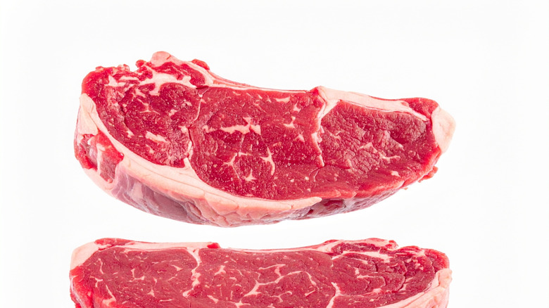 Raw steak with good marbling isolated on a white background