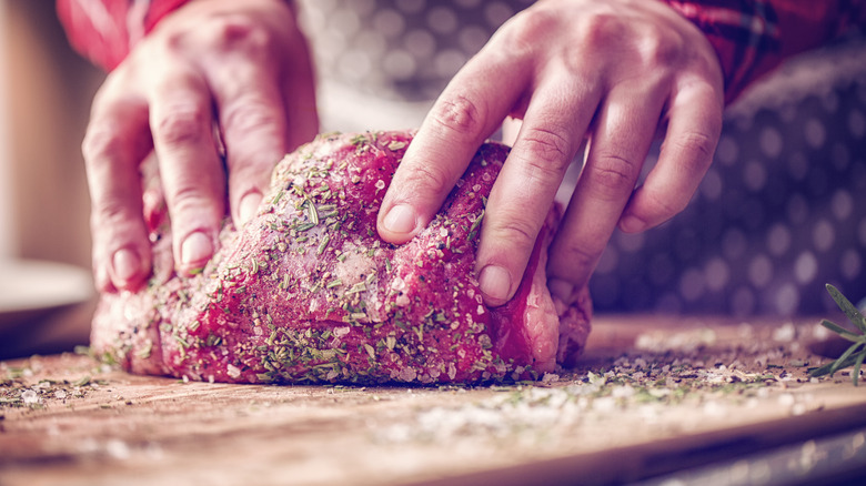 Person seasoning beef