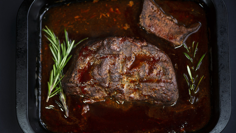 Beef in roasting pan with juices