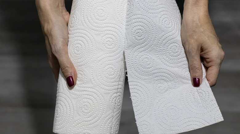 person tearing off paper towel