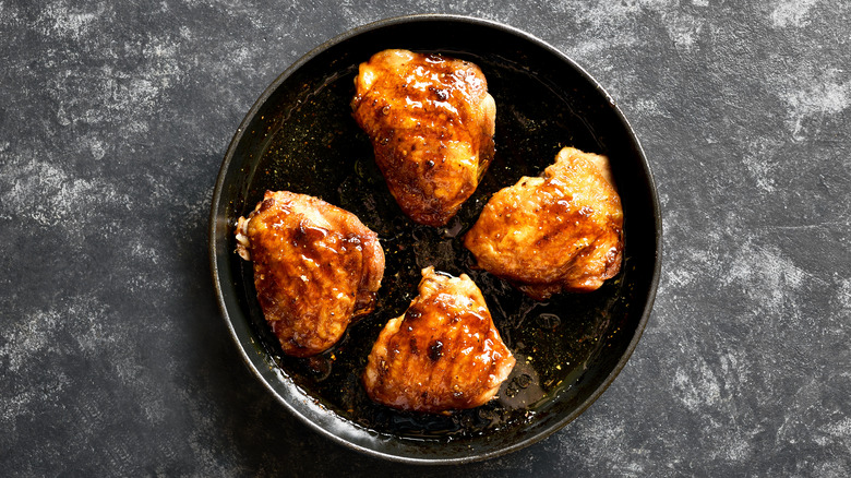 Chicken thighs in pan