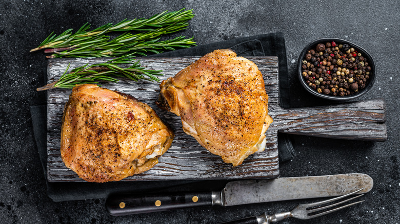 crispy chicken thighs on cutting board