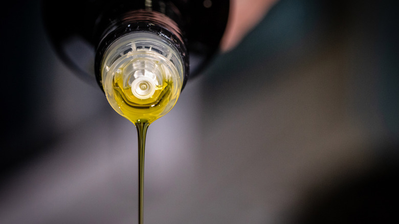 Olive oil is poured from a bottle