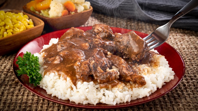 Beef tips over white rice