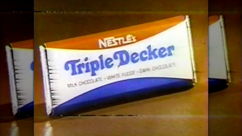 Still from a Nestlé Triple Decker Bar commercial, featuring a picture of a Nestlé Triple Decker Bar