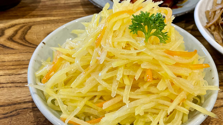 Shredded potatoes on white plate