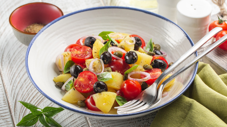 Greek potato salad in white bowl