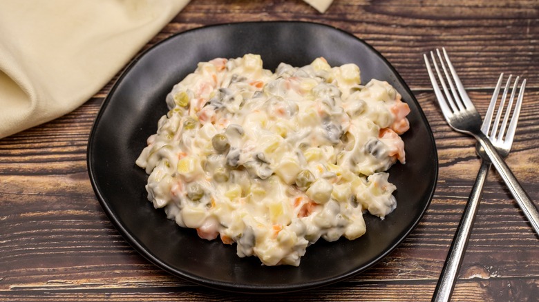 Olivier salad on black plate