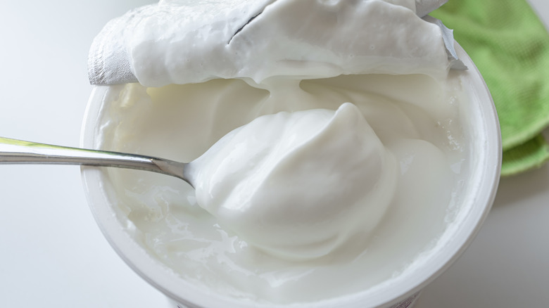 scooping yogurt from container