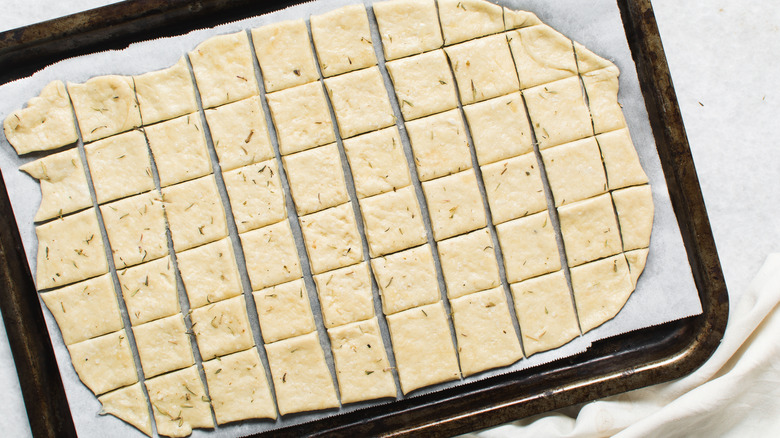 Cracker dough on a baking sheet, before being baked