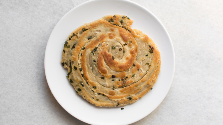 Scallion pancake on a white plate