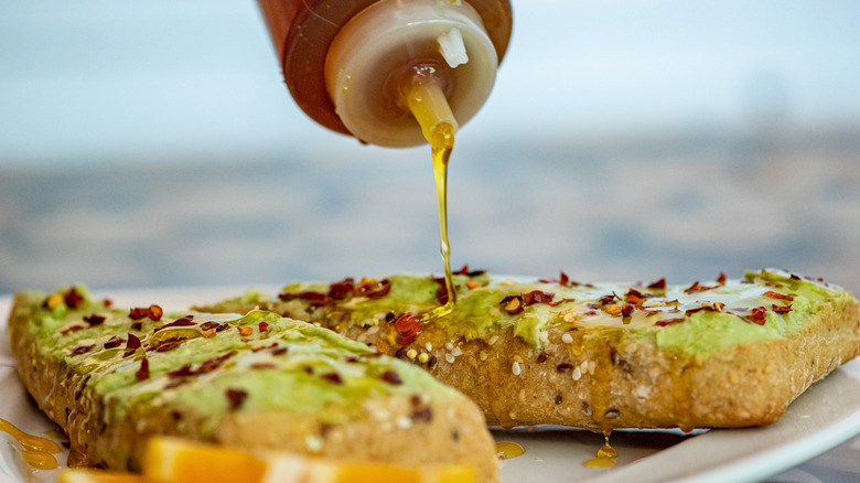 Drizzling honey on avocado toast