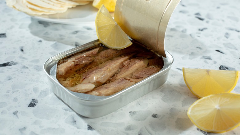 canned sardines and lemon wedges