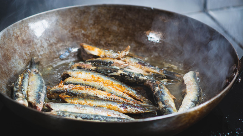 sardines cooking in frying pan