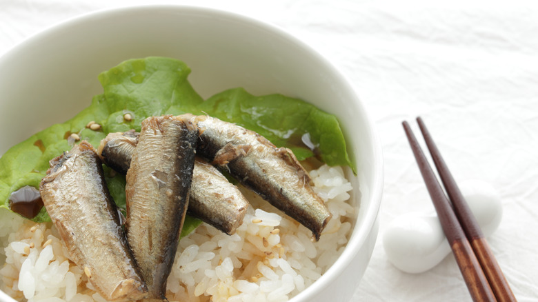 sardines on top of rice in bowl
