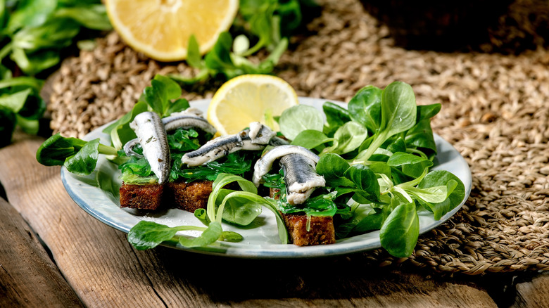 sardines on top of leafy salad