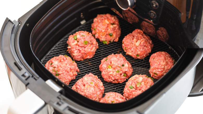 Raw meatballs in an air fryer