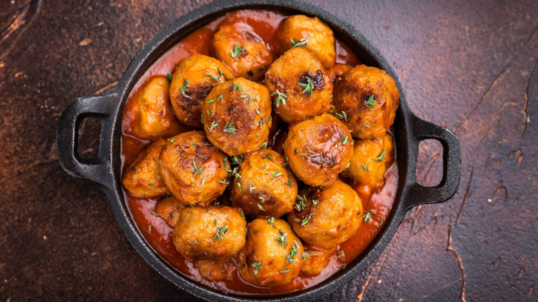 Meatballs and marinara sauce in a rustic bowl