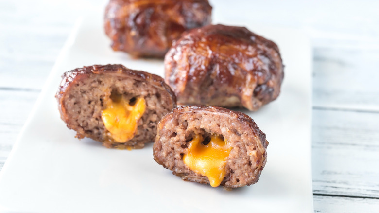 Meatballs stuffed with cheese on a white plate