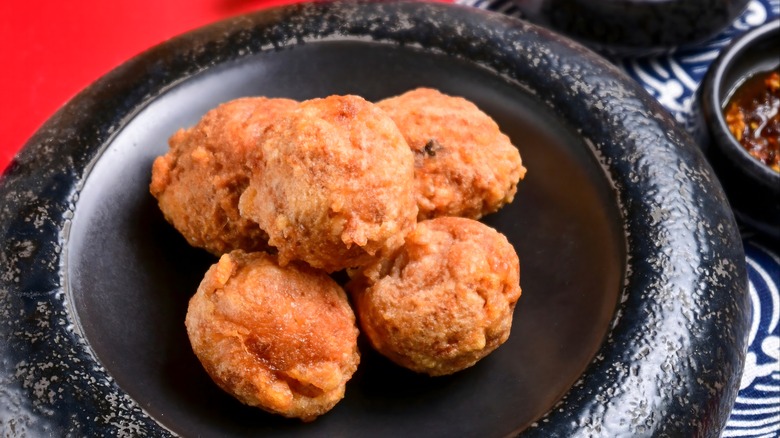 Fried meatballs on a rustic black plate