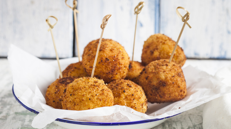 Arancini on a plate lined with paper