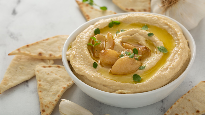 Hummus topped with roasted garlic cloves