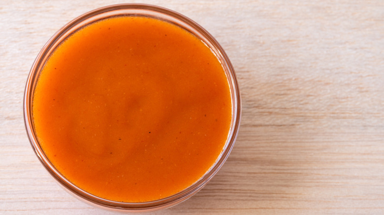Buffalo sauce in a small glass bowl.