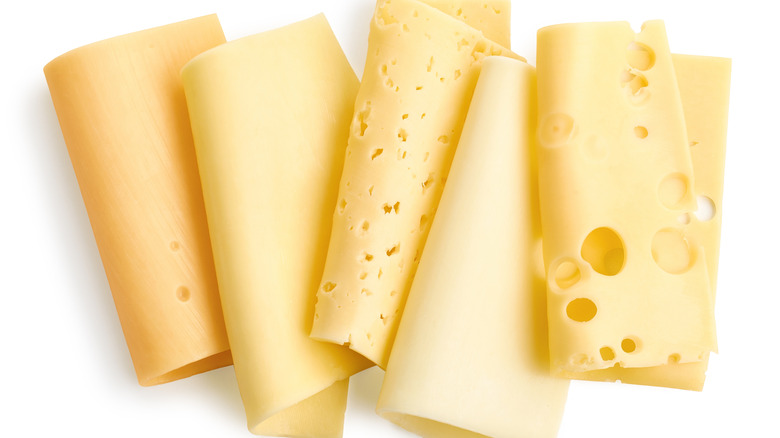 Close up view of several different types of sliced cheese, showing their different textures