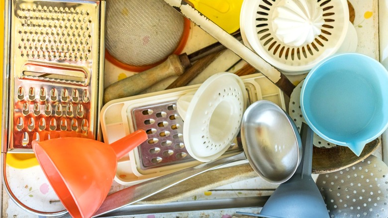 Messy kitchen utensil drawer with cooking utensils