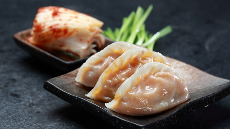 Steamed dumplings on black dish
