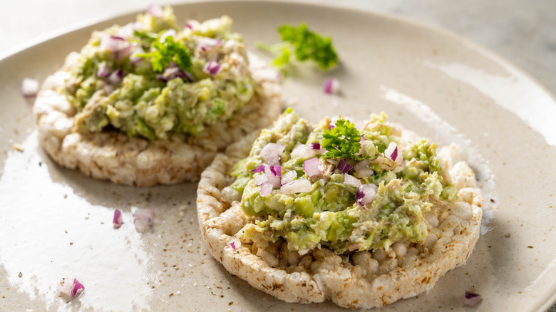 Tuna salad made with avocado on top of rice cakes