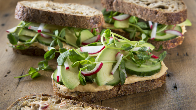Cucumber and avocado sandwich with hummus as the spread