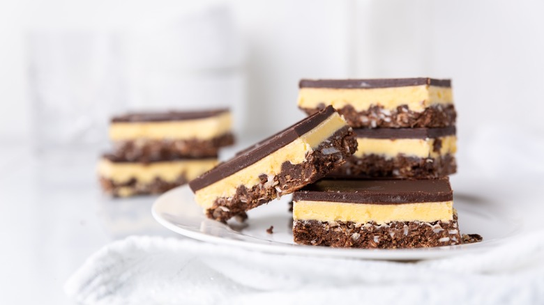 Nanaimo bars stacked on plate