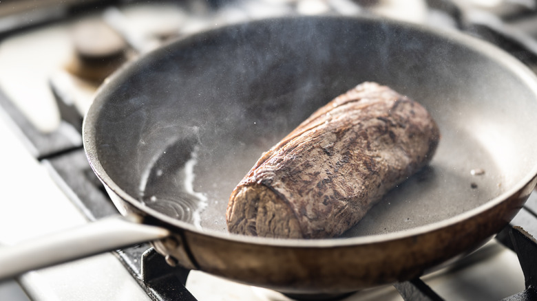 Tenderloin searing in a hot pan
