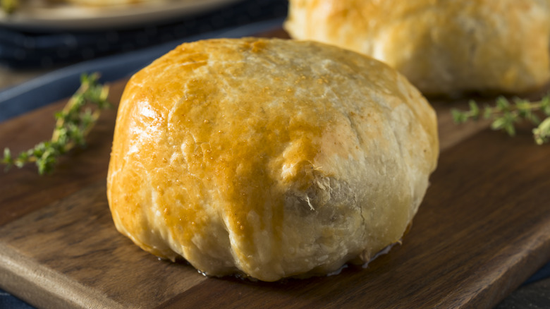 Individual beef Wellington on cutting board